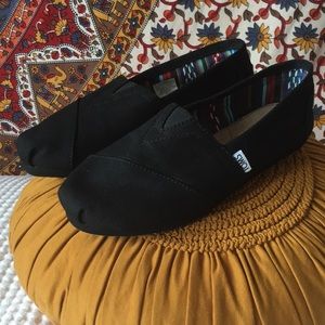 All black TOMS slip ons!